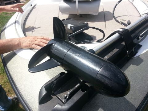 2003 Tracker Tournament - A trolling motor is mounted on the front deck of a boat, with a person's hands visible.