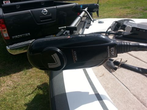 2003 Tracker Tournament - A black MotorGuide trolling motor is mounted on a white boat, with a black Nissan Frontier truck visible behind it.