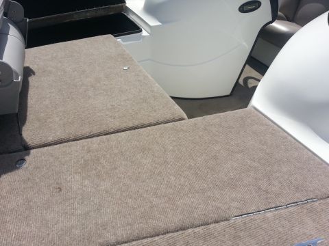 2003 Tracker Tournament - Interior view of a boat, showing carpeted surfaces and white fiberglass seating elements.