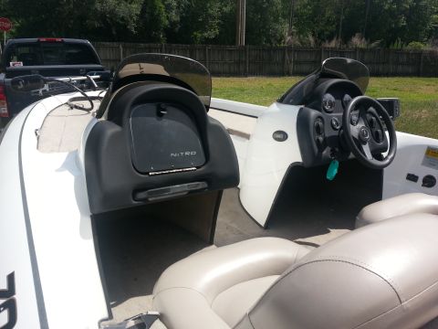 2003 Tracker Tournament - Interior view of a white boat with beige seating and a black dashboard console. The Nitro brand is visible on the console.
