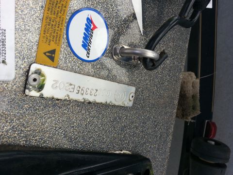 2003 Tracker Tournament - Close-up of a boat's hull showing an NMMA certified sticker and a VIN plate with the number PUJ23395E202.