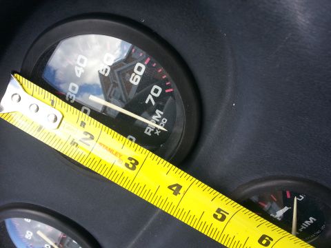2003 Tracker Tournament - A tape measure is placed across a tachometer gauge, obscuring part of the dial.