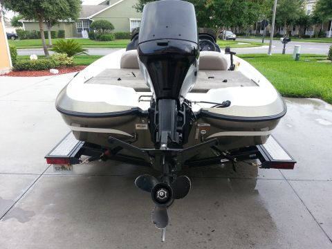 2003 Tracker Tournament - The rear of a boat with a powerful outboard motor is shown, parked on a concrete driveway.