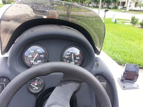 2003 Tracker Tournament - Close-up of a boat's dashboard, gauges and a steering wheel.