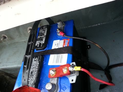 2003 Tracker Tournament - A close-up view of a blue marine battery with its electrical connections.
