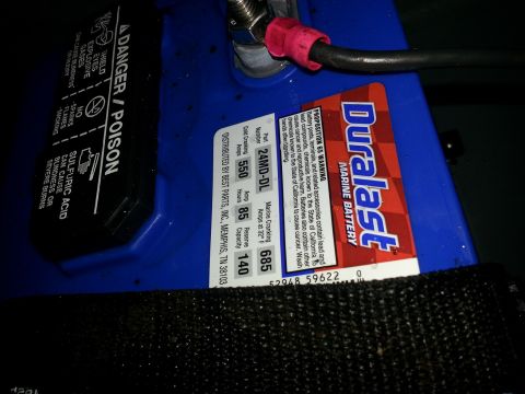 2003 Tracker Tournament - A Duralast marine battery is shown with its warning labels and specifications clearly visible.
