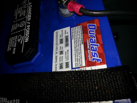 2003 Tracker Tournament - A blue Duralast marine battery is shown, with visible warning labels and specifications.