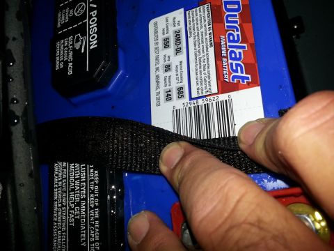 2003 Tracker Tournament - A Duralast marine battery is shown with warning labels and a securing strap.