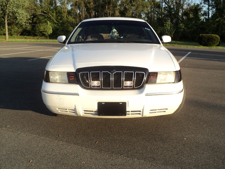 White 2000 Mercury Grand Marquis front grille with chrome accents