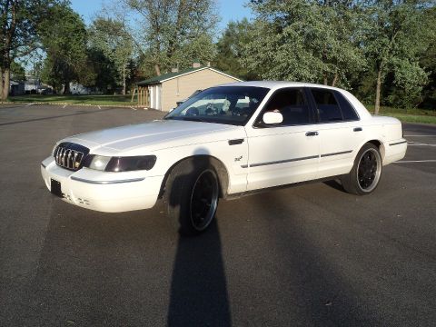 2000 Mercury Grand Marquis - White 2000 Mercury Grand Marquis with custom black wheels.