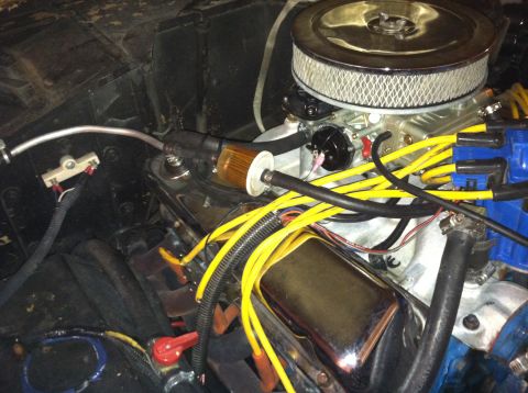 1976 Ford Bronco - Close-up view of a V8 engine, showing the air filter, carburetor, and spark plug wires.