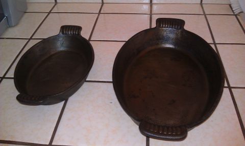1989 Ford Bronco - Two cast iron skillets, one oval and one round, are placed on a tiled surface.