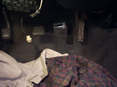 1991 Ford LTD Crown Victoria - Interior view of the floorboard and pedals of a 1991 Ford Crown Victoria, partially covered by a blanket.