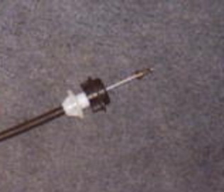 1991 Ford LTD Crown Victoria - Close-up of a clutch cable end, showing the metal tip and white plastic housing.