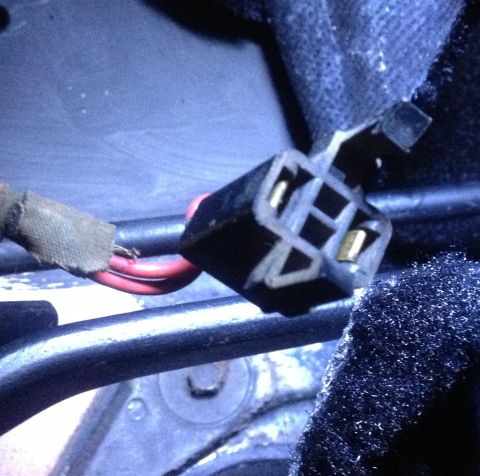 1978 Ford Bronco - Close-up view of an electrical connector with red wires, showing frayed insulation on one of the wires.