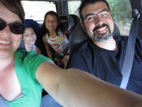 1992 Ford Explorer - A family smiles for a selfie while on a trip inside a vehicle.