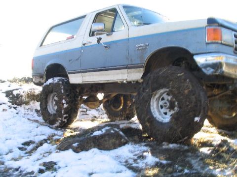 1988 Ford Bronco - This modified Ford Bronco navigates a challenging snowy and muddy terrain.