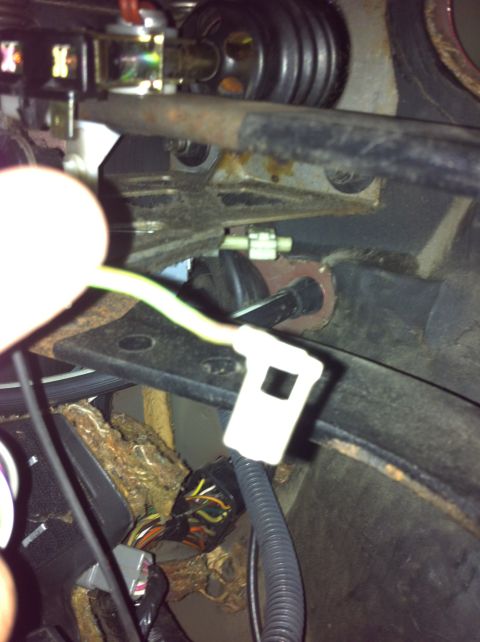 1995 Ford Mustang - Detail of the brake light switch and its wiring, likely under the dashboard of a vehicle.