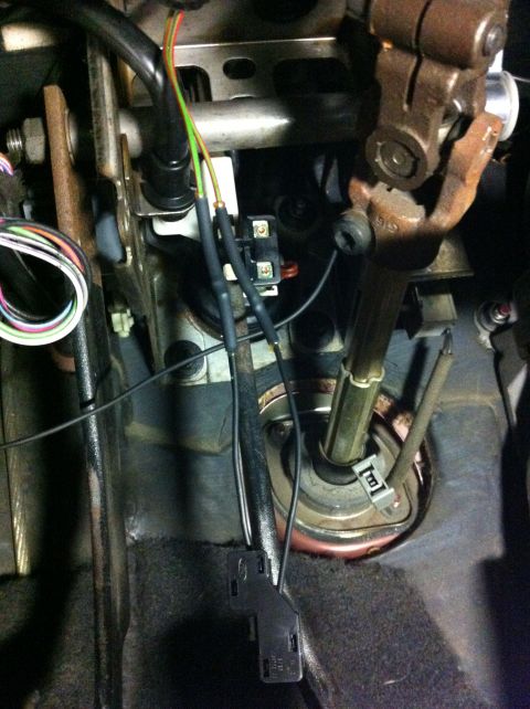 1995 Ford Mustang - Wiring and mechanical components are visible under the dashboard, likely related to the brake light switch.