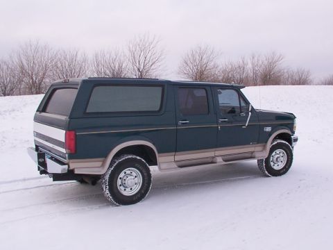 1995 Ford Bronco - This 1995 Ford Bronco Centurion features an extended cab and camper shell, seen here in a snowy outdoor setting.