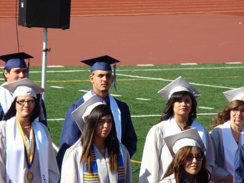 1989 Ford Bronco - Students in graduation attire stand on a field, possibly for a commencement ceremony.