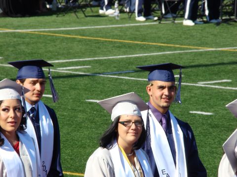 1989 Ford Bronco - Graduates pose for a photo on the field during a commencement ceremony.