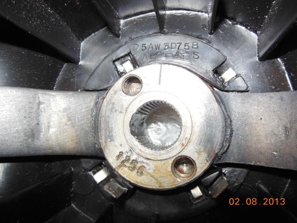 Close-up of a steering wheel hub with part numbers D5AW 3D758 and 1256 stamped on it