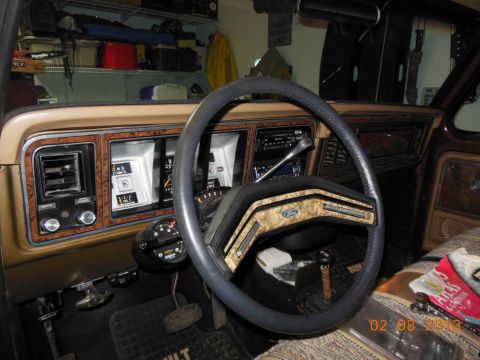 1979 Ford F-150 - The interior of a 1979 Ford F-150 shows its dashboard, steering wheel, and seating.