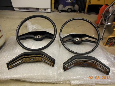 1979 Ford F-150 - Two Ford steering wheels and matching wood-grain trim pieces are laid out on bubble wrap.