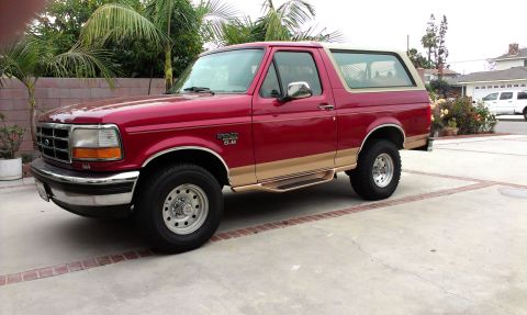 1994 Ford Bronco - This 1994 Ford Bronco is red with tan lower body trim and running boards.