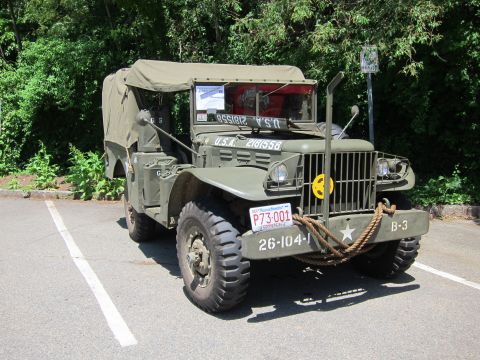 1991 Ford LTD Crown Victoria - Front three-quarter view of an olive drab military truck with yellow circle emblem and 26-104-1 bumper markings.