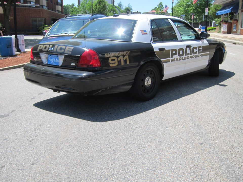 Black and white Marlborough Police car rear three-quarter, EMERGENCY 911 on trunk