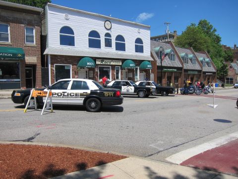 1991 Ford LTD Crown Victoria - downtown street scene with a black-and-white Marlborough police car and several other vehicles parked near storefronts.