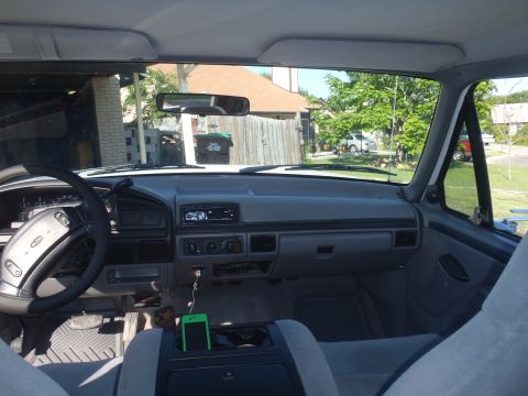 1997 Ford F-350 - Interior view of a 1997 Ford F-350, showing the dashboard and center console with a smartphone.