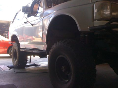 1990 Ford Bronco - This lifted Ford Bronco is shown from the side, with its large tires and elevated suspension.