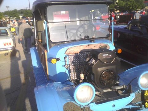 2003 Ford Crown Victoria - A custom-built light blue truck with a Kohler engine is displayed at an outdoor event.