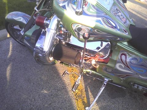 2003 Ford Crown Victoria - A custom motorcycle features intricate paintwork and a prominent turbocharger setup.