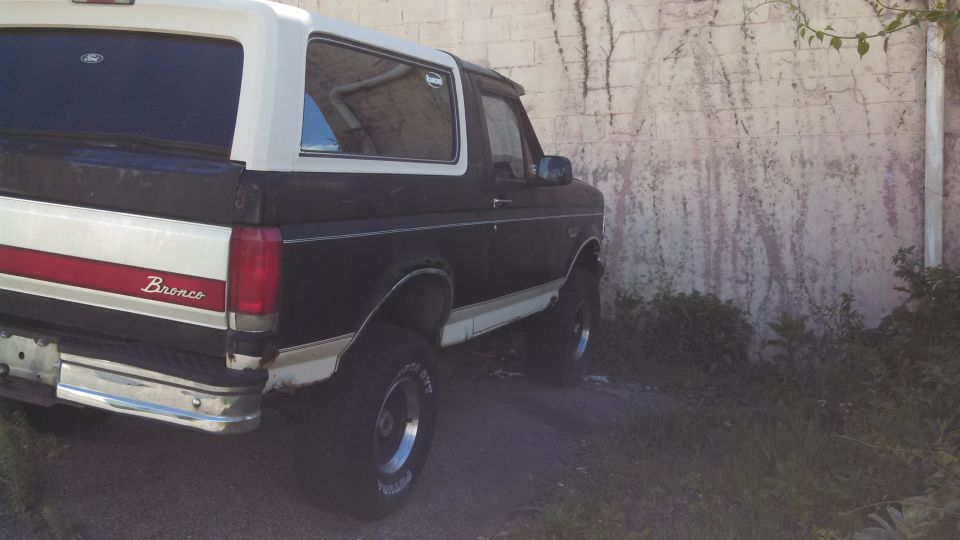 1993 Ford Bronco rear view, black and white two-tone paint with red stripe