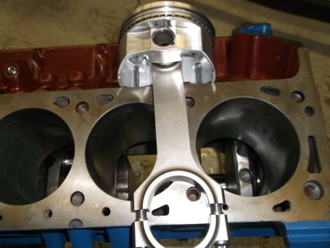 1970 Ford Mustang - Close-up view of an engine block assembly with a new piston and connecting rod.