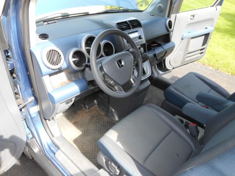 1996 Ford F-150 - The interior of a blue Honda Element is shown with the driver's side door open.