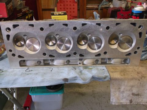 1970 Ford Mustang - An aluminum engine cylinder head is shown from the front, with visible valves and ports.