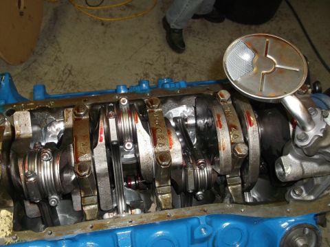 1970 Ford Mustang - Close-up view of an engine's crankshaft and oil pump assembly.