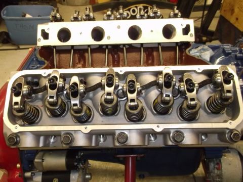 1970 Ford Mustang - Close-up view of an engine's valve train assembly, showing rocker arms and valve springs.