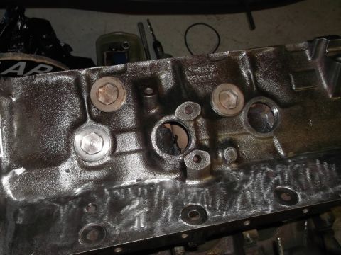 1964 Ford Galaxie - Engine block with various ports and fasteners, likely undergoing repair or rebuild.