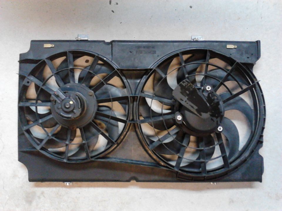 Pic of  Ford Windstar dual cooling fans/shroud, shows where I had to clearance shroud to fit my radiator/trans lines/water outlets. Smaller fan is located on passenger side of radiator.