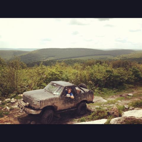 1995 Ford Bronco - Off-roading in a vintage Ford Bronco on a scenic, hilly terrain.