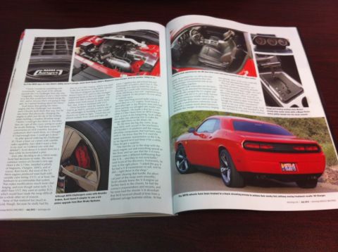 2010 Dodge Challenger - Article features a red 2010 Dodge Challenger, highlighting its rear 3/4 view and custom wheels.