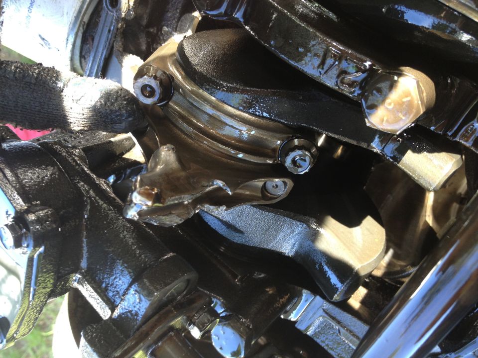 close-up of engine crankshaft and connecting rods with oil