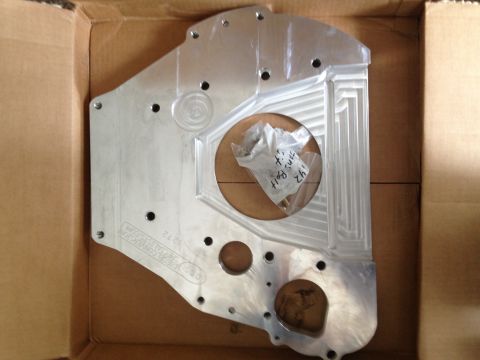 1995 Ford Bronco - A custom engine adapter plate is shown inside its shipping box, with a bag of hardware.