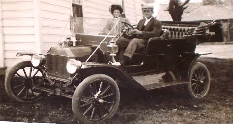 1912 Ford Model T - A couple poses in a black 1912 Ford Model T, captured in a historical photograph.